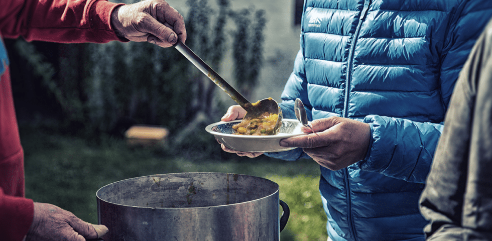 Food being served on a plate outdoors.