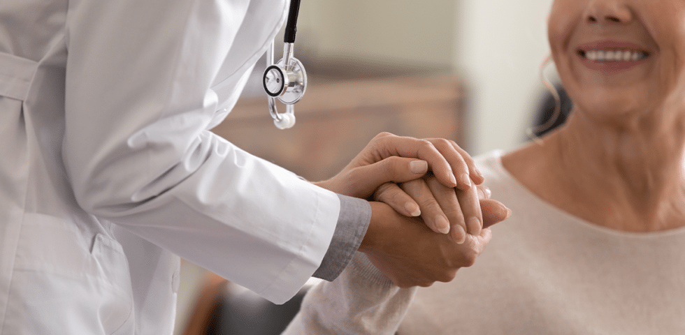 Doctor holding patient's hand.