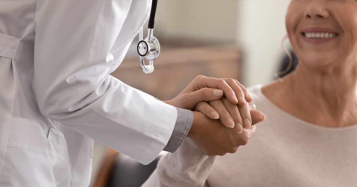 Doctor holding patient's hand.