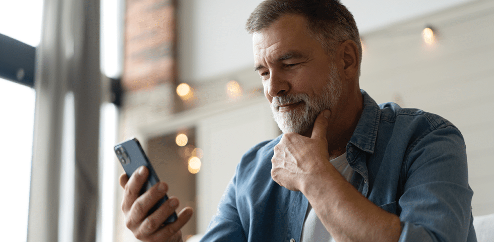 man considering receiving heart health care in rural Alaska on phone