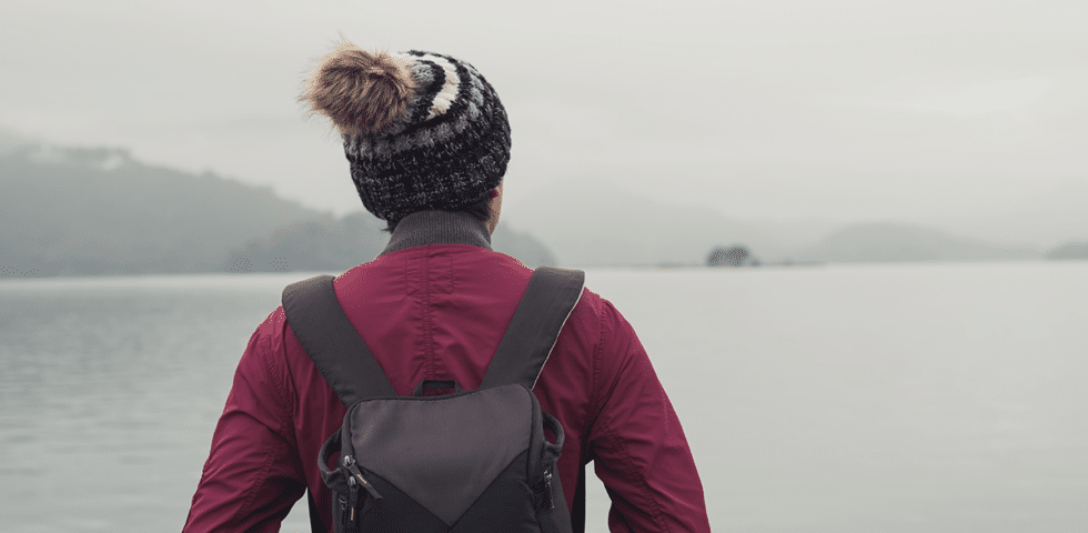 Woman looking across stormy Alaskan waters.