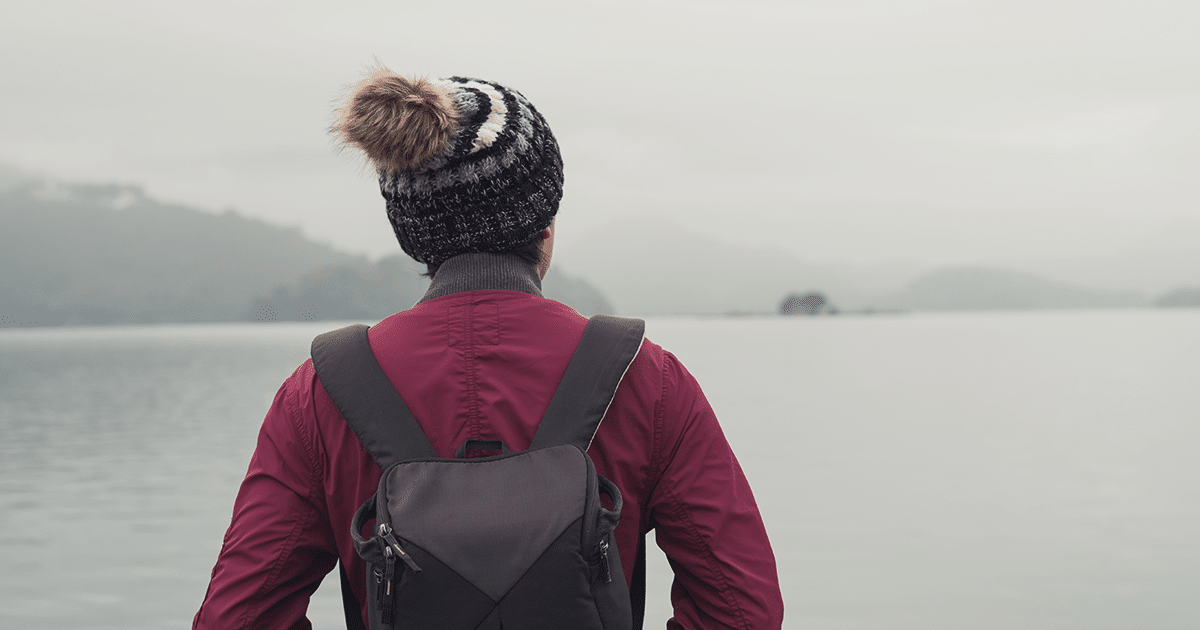 Woman looking across stormy Alaskan waters.